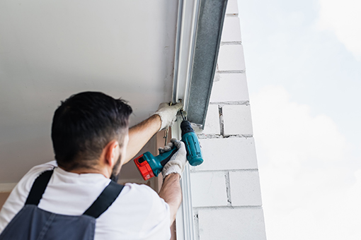 Carpenter Installing Impact Windows and Doors at a Commercial Building in Tampa FL