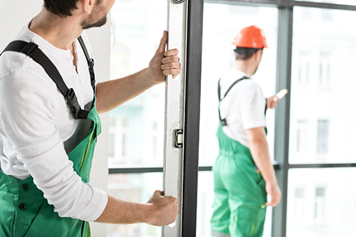 Two Tampa Men Installing an Impact Entry Door at a Tampa Residence