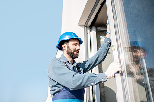 Carpenter Checking Newly Installed Impact Hurricane Windows at a Residential House in Tampa Bay